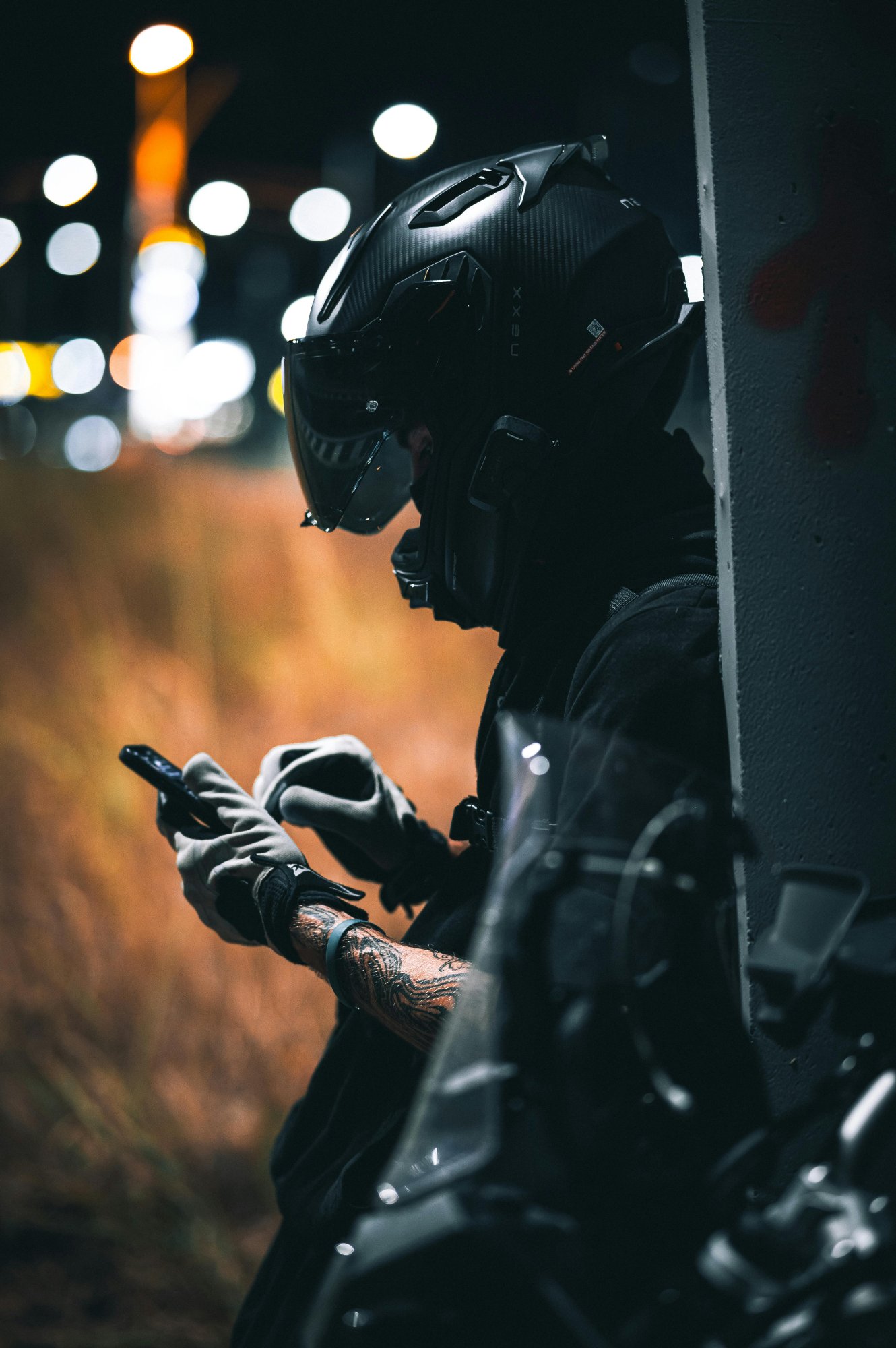 Rider with helmet checking phone — interface friction